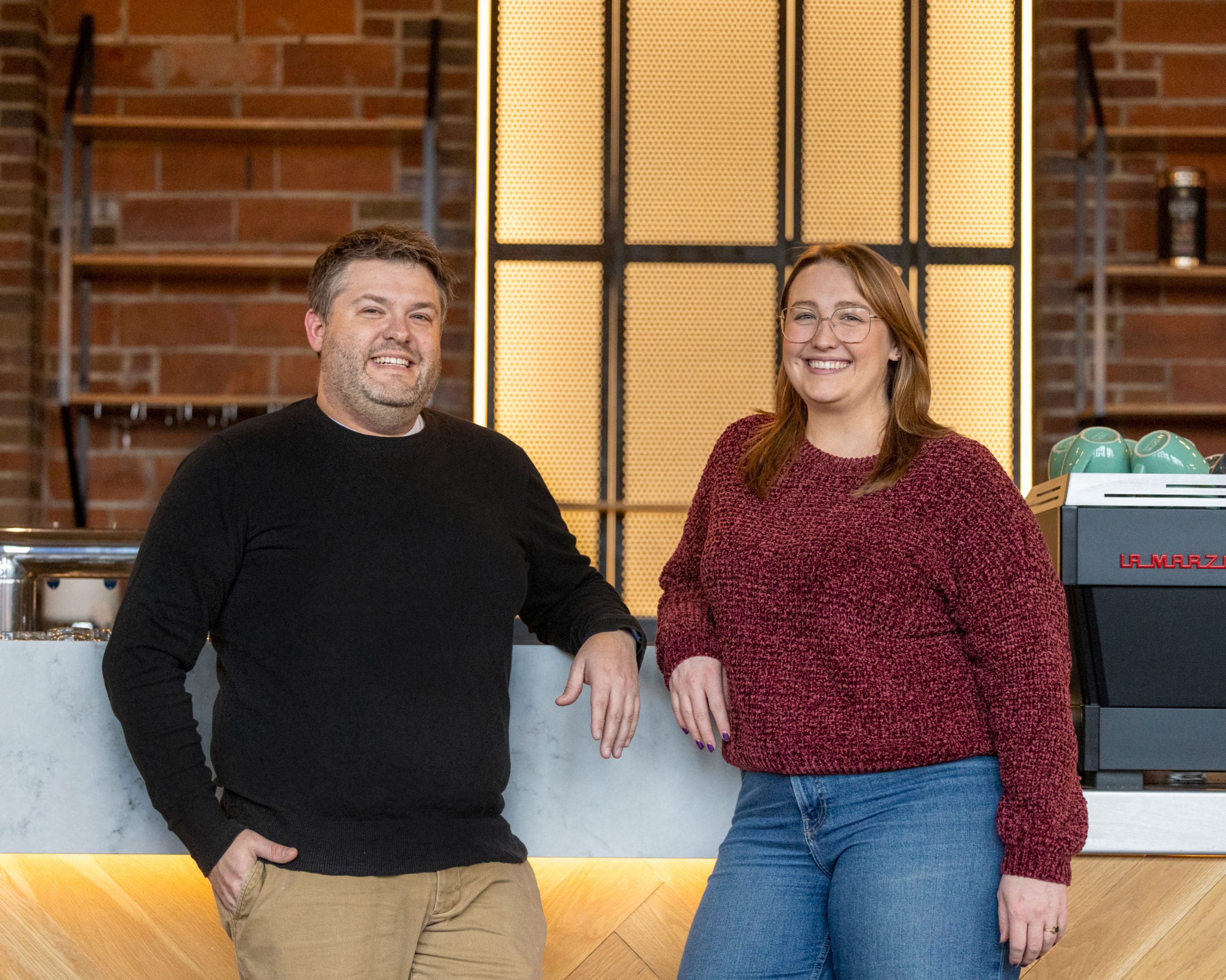 Rook Room Founders Tony Tandeski and Annelise Tarnowski standing at bar