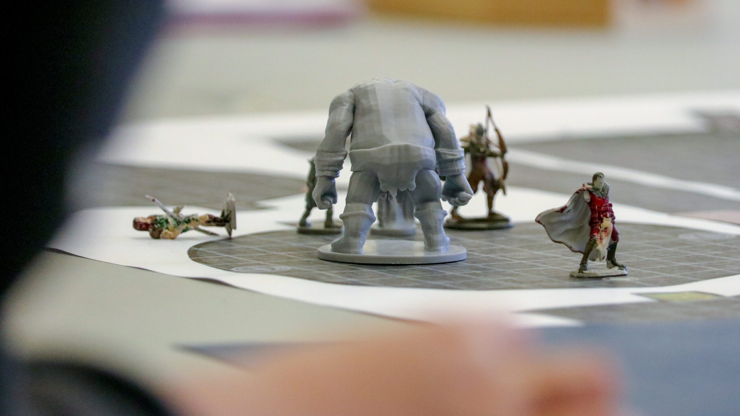 Learn to Slay D&D character tokens on table